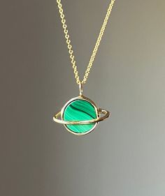 "This sweet pendant is made using a saturn setting that I handmade and had cast in brass, which is then plated in shiny 14k gold. A beautiful  banded green malachite is set in the center, and it hangs on an 18\" 14k gold-filled chain. Perfect for that space loving gal.  Also in silver, and other stones!" Gold Emerald Round Necklace, Green Clavicle Chain With Round Pendant, Green Round Pendant Clavicle Chain, Green Oval Pendant For Jewelry Making, Handmade 14k Gold Green Necklace, Handmade Green 14k Gold Necklace, Green Oval Nickel-free Necklace, Green Oval Pendant Jewelry Nickel Free, Oval Green Brass Jewelry