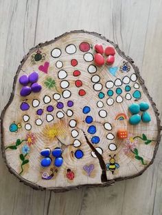 a wooden board game sitting on top of a piece of wood covered in lots of different colored buttons