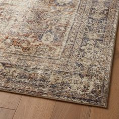 an area rug on the floor with wooden floors and wood parquets in the background