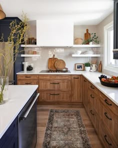 the kitchen is clean and ready for us to use it's counter tops are made of wood