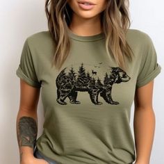 Bear Silhouette T-Shirt, Bear Graphic Tee, Nature Bear Shirt, Wildlife T-Shirt,Bear Inside Design, Animal Lover's Tee, Forest Bear Shirt, Unique Bear Shirt. Showcase your love for wildlife with our Bear Silhouette T-Shirt, featuring a detailed bear design inside a bear silhouette. Perfect for nature enthusiasts and animal lovers, this unique tee captures the spirit of the great outdoors. Made from high-quality fabric, it offers both comfort and durability for everyday wear. The unisex soft-style t-shirt puts a new spin on casual comfort. Made from very soft materials, this tee is 100% cotton for solid colors. Heather colors and sports grey include polyester. The shoulders have twill tape for improved durability. There are no side seams. The collar is made with ribbed knitting to prevent cu Trendy Crew Neck T-shirt With Bear Print, Summer Bear Print Short Sleeve T-shirt, Summer Bear Print Crew Neck T-shirt, Casual Short Sleeve T-shirt With Bear Print, Cute Short Sleeve Tops With Bear Print, Summer Bear Print Short Sleeve Tops, Black Crew Neck Top With Bear Print, Cute Bear Print Short Sleeve Tops, Cute Short Sleeve Top With Bear Print