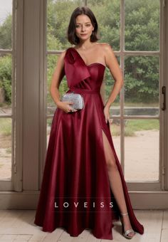 a woman standing in front of a window wearing a red dress with one leg slited