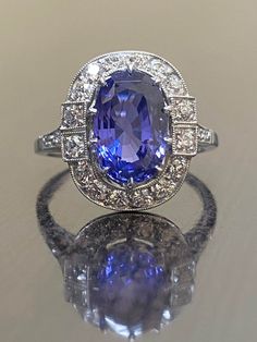 "DeKara Designs Collection Art Deco Inspired Extremely Elegant Handmade Elongated Blue Sapphire Antique Diamond Engagement Ring. Metal- 90% Platinum, 10% Iridium. Stones- No Heat Elongated Oval Genuine Violet Blue Sapphire 3.88 Carats, 22 Old European Cut Round Diamonds F-G Color VS1 Clarity, 0.82 Carats. Size- 7 1/2. FREE SIZING Handmade Art Deco Inspired Elongated Oval Ceylon Violet Blue Sapphire Antique Old European Cut Diamond Engagement Ring Entirely Made in Platinum. The center stone is a Blue Oval Diamond Ring, Blue Sapphire Engagement Ring Oval, European Cut Diamond Engagement Ring, Color Change Sapphire, Antique Diamond Engagement Rings, Blue Sapphire Engagement Ring, Elongated Oval, Tanzanite Diamond, Sapphire Engagement Ring Blue