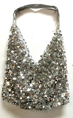 This cool purse is fully sequin beaded front & back tip to tip. Perfect for pairing up with your costume or to carry with you in event! Glamorous Sequin Bag For Night Out, Sequin Bags For Night Out And Party Season, Summer Party Embellished Bags, Glamorous Party Bags With Sequins, Glamorous Sequin Party Bags, Embellished Party Bags For Summer, Silver Beaded Sequin Fabric For Party, Beaded Sequin Fabric For Party, Silver Sequin Party Bags