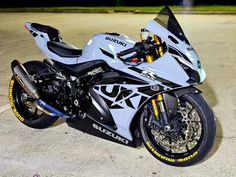 a white and black motorcycle parked in a parking lot