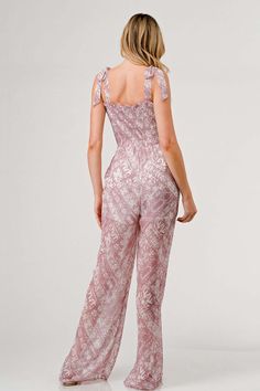 Make a fashion statement with the Printed Tie Shoulder Wide Leg Jumpsuit, a chic and versatile piece for your wardrobe. The tie shoulder detailing adds a touch of charm and character to this stylish jumpsuit. Featuring a trendy print, the wide leg silhouette exudes a relaxed and contemporary vibe that is perfect for any occasion. Dress it up with heels for a sophisticated look or opt for sandals for a more casual feel. Features: Smocked, Tied, Ruched, Pocketed, Frill Sheer: Opaque Material compo Spring Sleeveless Jumpsuits And Rompers With Tie Straps, Spring Day Out Jumpsuits And Rompers With Tie Straps, Chic Strapless Jumpsuit With Tie Waist, Spring Vacation Jumpsuits And Rompers With Tie Straps, Chic Vacation Jumpsuits And Rompers With Tie Waist, Spring Jumpsuits And Rompers With Tie Straps, Chic Tie-back Jumpsuits And Rompers, Spring Tie Back Overall Jumpsuit, Spring Tie Back Overall Jumpsuits And Rompers