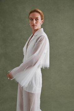 The Tulle Notch Collar Blazer is Alexandra Pijut’s ethereal take on bridal suiting. Layers of lightweight tulle create an airy silhouette paired with a statement lapel crafted in duchess satin. This blazer features irregular crystal drop beading and is perfect for any city hall wedding. Tulle Blazer Jackets, Tulle Blazer, Tulle Jacket, White Tulle Skirt, December 2nd, Bridal Jacket, Tulle Sleeves, Duchess Satin, City Hall Wedding