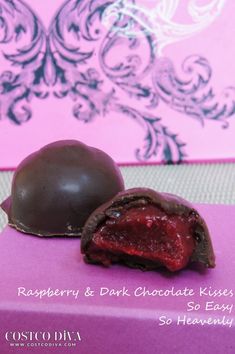 two pieces of chocolate sitting next to each other on a pink tablecloth covered surface