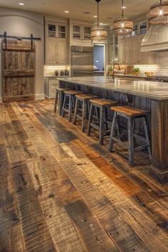 a large kitchen with wooden floors and an island