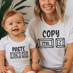 Behold our Ctrl C and Ctrl V matching set - a delightful fusion of copy-paste flair for both parent and baby! Whether you're commemorating a christening, on the hunt for the perfect baby gift, or gearing up for the much-anticipated Fathers and Mothers Day, this charming duo is set to steal the show. **Parent T-Shirt (Ctrl C Indulge in comfort with our adult T-shirt, meticulously crafted from a medium-weight 100% cotton fabric for year-round cosiness. The classic fit ensures a laid-back wear suitable for any occasion - be it casual gatherings or semi-formal affairs. The crew neckline adds a touch of timeless elegance, ensuring this tee effortlessly blends into your versatile wardrobe. But our commitment goes beyond style - this tee is fashioned from 100% US cotton, responsibly grown and har White Tops With Funny Print For Playtime, White Tops With Custom Parenting Print, White Top With Custom Parenting Print, White Top With Custom Print For Parenting, White Tops With Custom Print For Parenting, Thoughtful Baby Gifts, Vest Set, Animal Humour, Copy And Paste