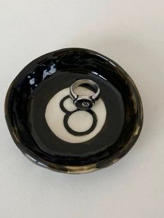 a black and white bowl with two rings on it