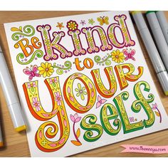 a coloring book with the words be kind to your self on it and some markers