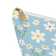 This Sky Blue Daisy Accessory Pouch with T-bottom boasts a cute and pretty floral design perfect for the summer season. Its light blue color adds a sweet touch, making it a stylish and functional option for storing your makeup, school supplies, and more. Stay organized and stylish with this delightful accessory pouch. Our t-bottom pouches can be used for pretty much anything. They make excellent pencil cases and cosmetic travel bags. They are constructed from a durable material with a zipper closure. .: 100% Polyester.: With non-woven laminate inside.: Assembled in the USA from globally sourced parts Small Length, in 8.66 Width, in 2.36 Height, in 4.72 Blue Spring Flowers, Blue Daisy, Travel Cosmetic Bags, Accessory Pouch, Light Blue Color, Small Bag, Phone Case Accessories, Pretty Cool, Zipper Pouch