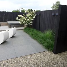 an image of a modern garden design with grass and rocks in the foreground, on instagram