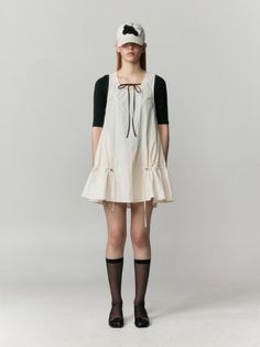 This dress is a sleeveless tunic with a wide, round neckline that provides a comfortable and relaxed fit around the shoulders and neck. The silhouette is an A-line shape, flaring gently from the shoulders to the hem, offering a flowy and flattering drape. It features adjustable drawstrings at the lower sides, which can be cinched to create a ruched effect and alter the garment's shape. The fabric appears to be lightweight and probably breathable, making it suitable for warm weather or layering.- The dress suggests versatility as it could pair well with a variety of other shades and patterns.- The absence of sleeves and the airy cut make it ideal for summer days or as a layering piece over long sleeves for cooler weather.- The hem of the tunic is finished with a ruffle, adding a playful and Flowy Fabric Aesthetic, Spring Sleeveless Pinafore Dress With Tie Straps, A-line Sleeveless Dress With Ruffles For Daywear, Beige A-line Sleeveless Dress For Daywear, Sleeveless Pinafore Dress For Daywear, Cotton Pinafore Dress For Daywear, Spring Sleeveless Sundress Pinafore, Casual Flared Hem Summer Dress, Summer Sundress Pinafore Dress