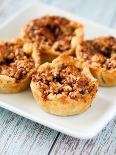 several small pies on a white plate