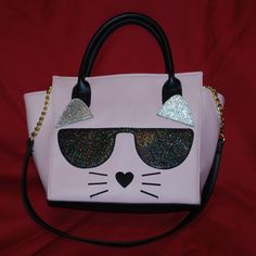 Features: * Stitched On Cat Face With Sparkly Shades And Sparkly Floppy Ears, Black Heart Nose & Whiskers * 2 Rolled Carry Handles Plus Shoulder Strap Which Can Be Tucked Inside When Not In Use * Zip Closure * Interior: Zip Pocket On One Side, Slip Pocket Plus 3 Pen Holder Pockets Opposite * Approx. 10.5" W X 4" D X 9" To 10" H Please Note: Although This Purse Has Never Been Used, Somehow It Got A Couple Black Marks Sitting In My Closet (See Last 2 Pics). Luckily, They're On The Back Side. Pink Tote Bags For Party, Pink Tote Bag For Party, Pink Cat Design Shoulder Bag, Pink Party Tote Bag, Pink Rectangular Bag With Cat Design, Pink Rectangular Shoulder Bag With Cat Design, Everyday Pink Bag With Cat Design, Cute Pink Bag With Cat Design, Cute Pink Bag With Detachable Strap