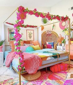 a bed with pink flowers on the headboard and foot board is in a bedroom