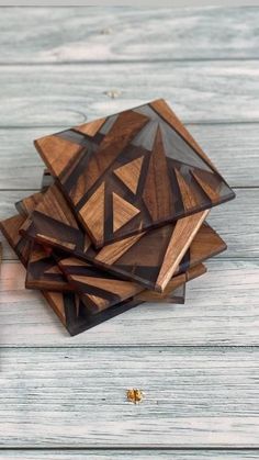 several pieces of wood are stacked on top of each other in the shape of triangles