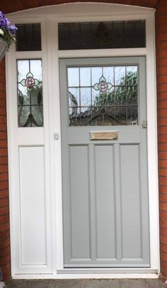 a white front door with stained glass windows