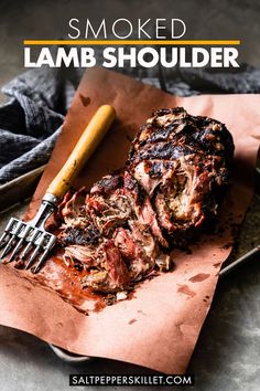 a piece of meat sitting on top of a table next to a fork