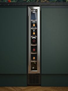 a stainless steel wine cooler with several bottles in it's door and shelves on the wall