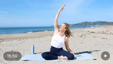 a woman is doing yoga on the beach