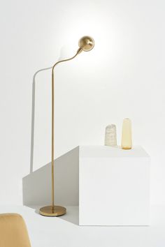 a lamp sitting on top of a white box next to a chair