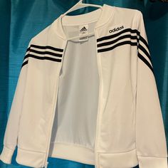 Youth 10/12 White With Black Stripe Zip Up Never Worn But Tags Aren’t On Anymore Casual White Tops For Playwear, White Tops For Fall Playwear, Sporty Long Sleeve Tops For Playwear, White Top With Three Stripes For Fall, Adidas Casual Tops For Playwear, Casual Adidas Tops For Playwear, White Fitted Playwear Tops, Sporty Long Sleeve Playwear Top, Adidas Zipper Jacket