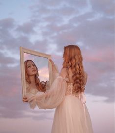 Princess wearing a dreamy dress holds a mirror up to the sunset sky.  Girl with red hair wearing a cream dress looks at her reflection in a dreamy whimsical Photoshoot. Fairytale Theme Photoshoot, Whimsical Editorial Fashion Photography, Dreamy Beach Photography, Fairytale Studio Photoshoot, Fairytale Photoshoot Princesses, Pink Fairy Photoshoot, Mystical Photoshoot Ideas, Art Inspired Photoshoot, Whimsical Beach Photoshoot