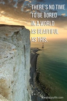 a lighthouse on the edge of a cliff by the ocean