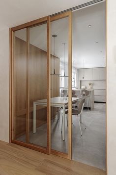 an open glass door leading to a dining room