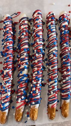 several red, white and blue candy canes are lined up