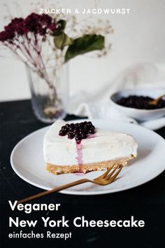 a piece of cake on a plate with a fork and bowl of berries in the background