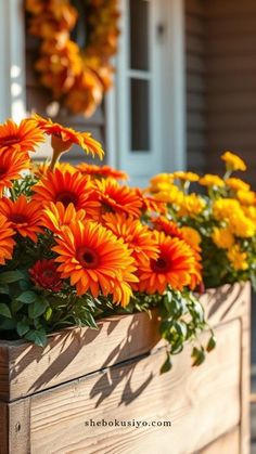 orange and yellow flowers in a wooden planter