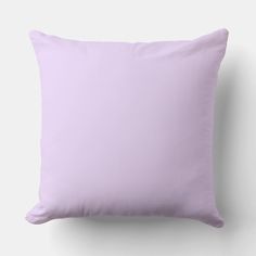 a light purple pillow on a white wall