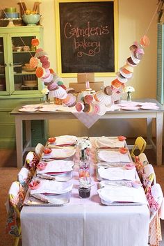 the table is set with cupcakes on it