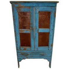 an old blue cabinet with glass doors on the top and bottom, against a white background