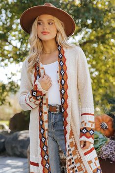 Our Beige Tribal Print Fringe Duster Cardigan is perfect for any fall occasion! This duster-length cardigan showcases a bold tribal print and a fringe hem for added style. It offers both comfort and a touch of bohemian flair, making it perfect for layering throughout the season. Layer it over a basic top and pair with jeans, ankle booties, and matching accessories to complete the look. Bohemian Fair Isle Cardigan For Fall, Bohemian Fair Isle Pattern Cardigan For Fall, Bohemian Fall Festival Cardigan, Fringe Long Sleeve Cardigan For Festivals, Long Sleeve Boho Print Outerwear For Fall, Bohemian Cardigan For Fall Layering, Beige Bohemian Cardigan For Fall, Beige Fringe Cardigan For Fall, Bohemian Beige Cardigan For Fall