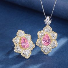 ✰ This stunning set includes a teardrop-shaped floral pendant necklace and a delicate pink diamond open ring, perfect for adding a touch of romance and sophistication to any outfit. Inspired by the delicate beauty of cherry blossoms, each piece is adorned with exquisite pink gemstones and framed in gold-plated accents, creating a harmonious blend of elegance and charm. ✰ The teardrop pendant necklace features a unique flower design with sparkling pink crystals that catch the light beautifully. The adjustable chain ensures a perfect fit, allowing you to style it with ease for both formal events and everyday wear. Complementing the necklace is a stylish open ring with a pink gemstone centerpiece, surrounded by intricate floral details that echo the beauty of the pendant. The ring's adjustabl Pink Diamond Jewelry, Diamond Jewelry Set, Floral Pendant Necklace, Outfit Inspired, Unique Flower, Delicate Beauty, Floral Pendant, Fashion Jewelry Sets, Teardrop Pendant