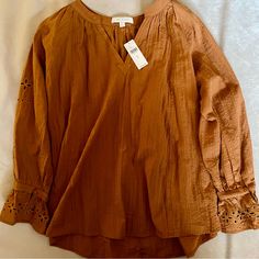 Oversized Peasant Top With Eyelet Lace Detail On The Sleeves. V- Neck. Cinches In At The Wrist. Looks More Brown In The Light. Fits Up To A Medium. Mrsp $128 Measurement (Top): Bust: 22 In Length: 25 In Sleeve Length: 25 In Cotton Peasant Top For Fall Vacation, Fall Cotton Peasant Top For Vacation, Cotton Peasant Top For Vacation In Fall, Orange Relaxed Fit Blouse For Vacation, V-neck Peasant Top For Fall Vacation, Brown Fall Blouse For Vacation, Brown Blouse For Fall Vacation, Orange Relaxed Fit Blouse For Day Out, Relaxed Fit Orange Blouse For Day Out