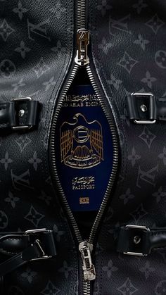 the inside of a black louis vuitton bag with a blue and gold emblem on it