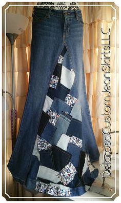 a woman's jean skirt made out of old jeans with patchwork on the bottom