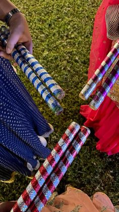 two women are holding colorful umbrellas in their hands and one woman is wearing a red dress