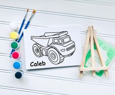 a drawing of a truck with the word caleb on it next to paintbrushes and paints