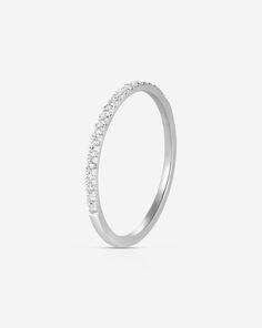 a white gold wedding ring with small diamonds on the side, set in 18k white gold