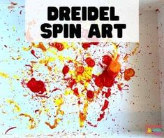 the words dreidel spin art are in front of an image of paint splatters