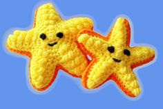 two crocheted yellow and orange stars on a blue background