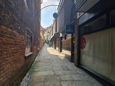 an alley way with brick buildings and windows