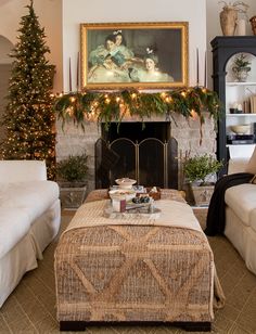 a living room filled with furniture and a fire place covered in christmas decorations next to a fireplace